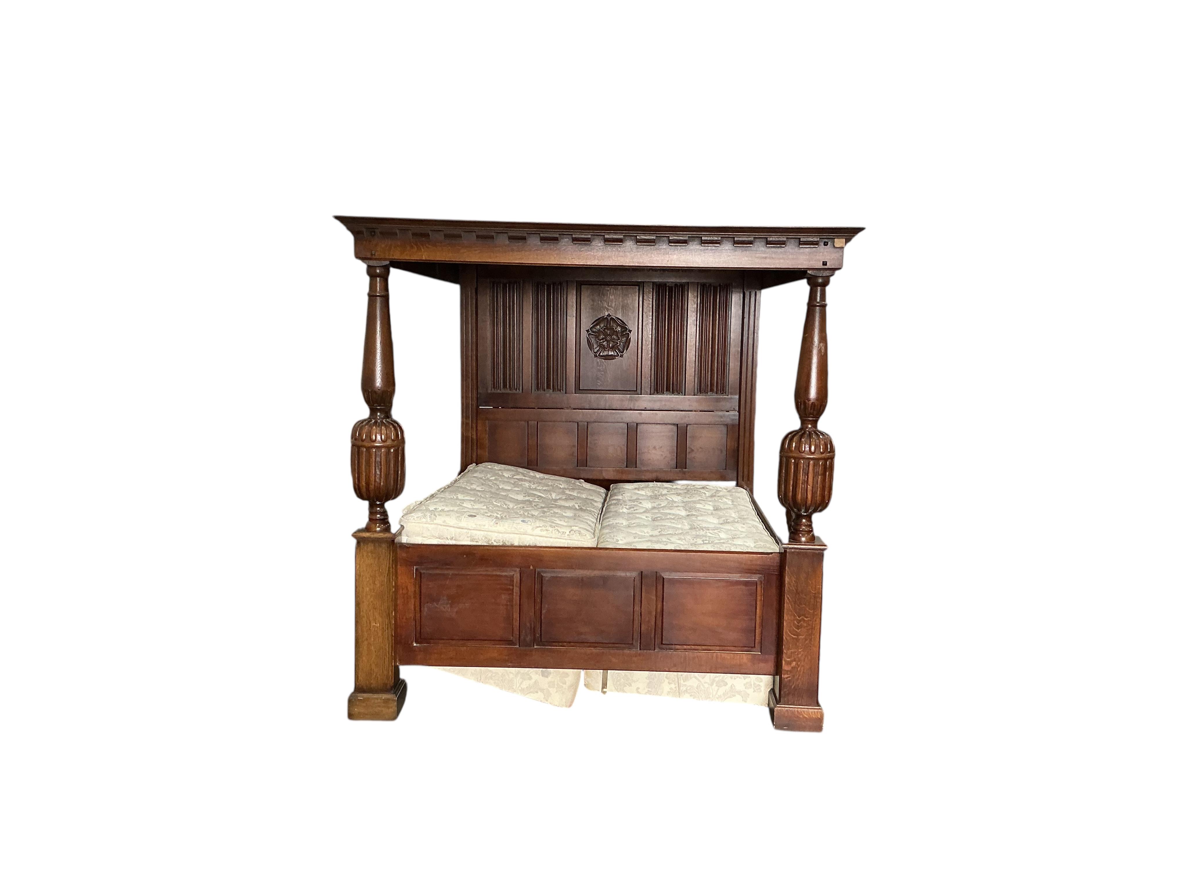 An 18th century style carved oak four poster bed frame, width 190cm, length 230cm, height 198cm with mattress